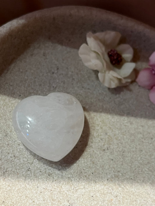 Heart shaped clear quartz on a stone plate
