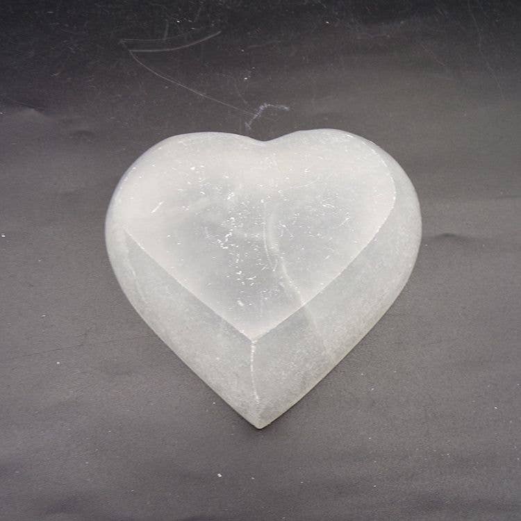 Selenite heart shaped bowl, displaying the bottom.
