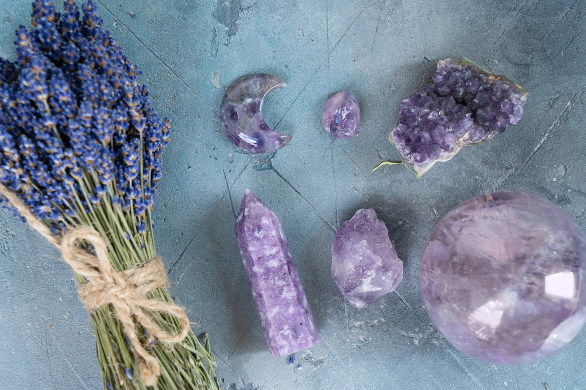 Advent calendar collection banner for The Tiny Topaz showing a bouquet of lavender tied together with rope, next to a variety of purple amethyst crystals.