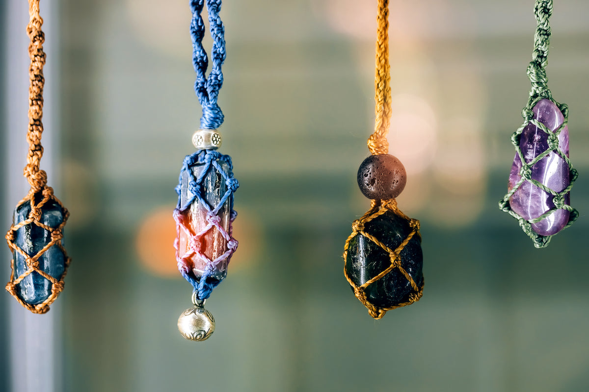 Keyrings collection banner for The Tiny Topaz showing four colourful crystals in necklace rope hanging in a row.