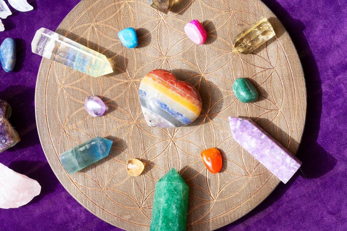 Accessories collection banner for The Tiny Topaz showing colourful crystals arranged in a circle, pointing towards a colourful heart crystal in the centre.