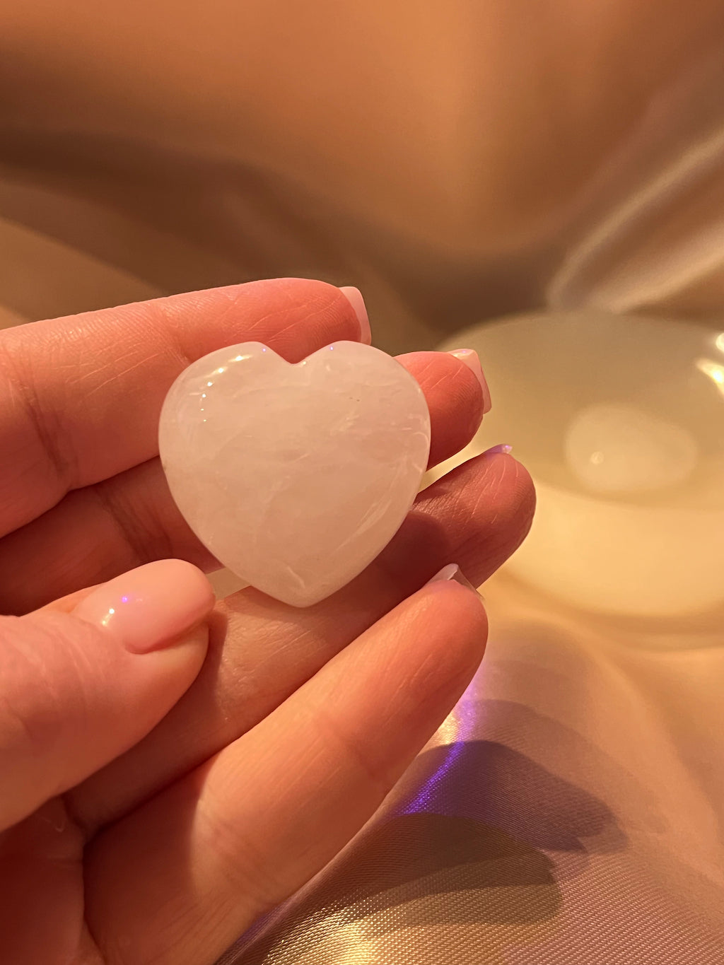 Heart shaped clear quartz on a bronze background